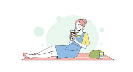 Relaxed Woman Sipping Iced Coffee on Picnic Blanket During Leisure Time Outdoors