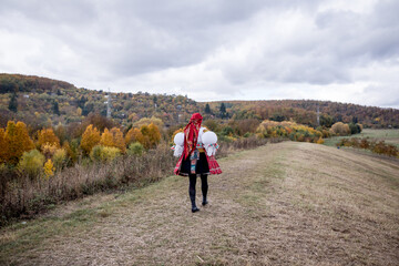 Obraz premium Traditional czech folk costume (kroj), cultural heritage from the Czech Republic (Czechia, Southern Moravia, Central Europe), the woman wearing the national dress (costume, attire, clothing).