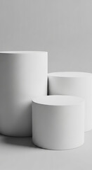 Three white cylindrical podiums on gray background, showcasing product display scene, ideal for mockup or advertisement, offering blank space for text