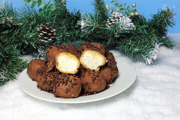 Chocolate profiteroles  served on a plate. Christmas Dessert