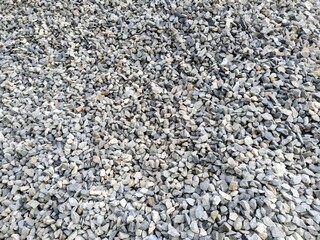 A pile of rocks in a natural setting. The rocks are of various shapes, sizes, and colors.
