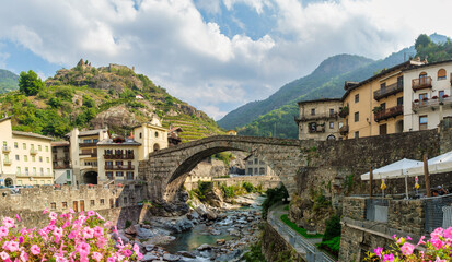Historic Pont-Saint-Martin bridge in Valle d&rsquo;Aosta, Italy. Scenic Alps, medieval architecture
