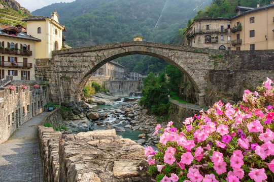 Historic Pont-Saint-Martin bridge and Forte di Bard in Valle d&rsquo;Aosta, Italy. Scenic Alps, medieval architecture