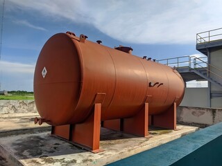 A large rusted industrial storage tank.