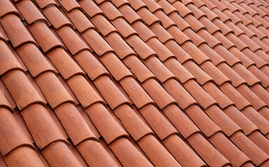 Terracotta clay roof tiles with curved profile in overlapping rows