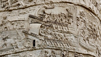 Rome, Italy - 11 January 2025. Trajan’s Column features troops traveling by boat using gangways,...