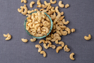 Bowl of cashew nuts on gray background