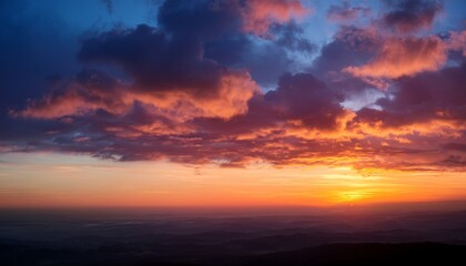 Fototapeta premium Vibrant Sunset Glow Illuminating Soft Clouds In The Horizon During Twilight Hours