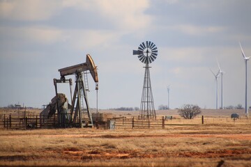 US Oil Rig. Pump and Wind Turbines Powering Texas Energy Plant