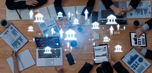 A dynamic workspace featuring professionals engaging in financial analytics using digital devices, overlaid on a global map, visualizing market trends and growth opportunities. Trope