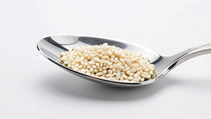 Close-up of Silver Spoon Holding Raw White Sesame Seeds on White Background