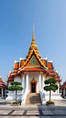 Stunning Thai Temple with Golden Spire Against Clear Blue Sky
