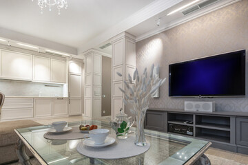 A living room with an elegant neoclassical interior and a beautiful table setting.
