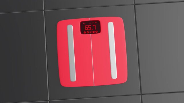 Red smart weight scale on black tiled floor
