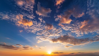 Obraz premium The Sky Is Filled With Clouds And The Sun Is Setting Creating A Beautiful And Serene Atmosphere