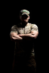 Portrait of Soldier Arms Crossed on Black Background