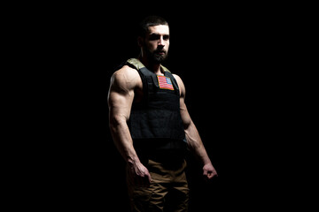 Naklejka premium Bodybuilder Soldier With Bulletproof Vest on Black Background