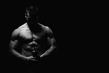 Fototapeta premium Young Man Holding a Bomb on Black Background