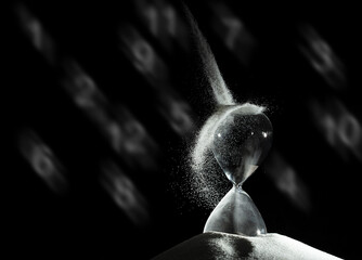 Hourglass add more sand of time on white sand over black background. White hourglass show more time Deadline extended time management hope concept hour glass, life clock passing by