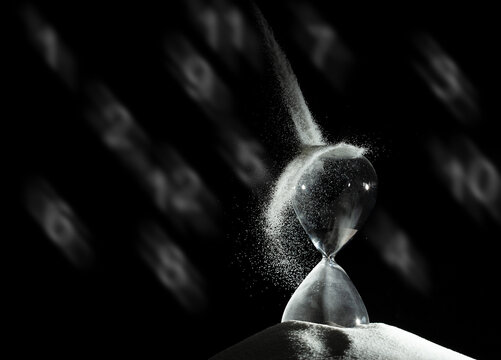 Hourglass add more sand of time on white sand over black background. White hourglass show more time Deadline extended time management hope concept hour glass, life clock passing by