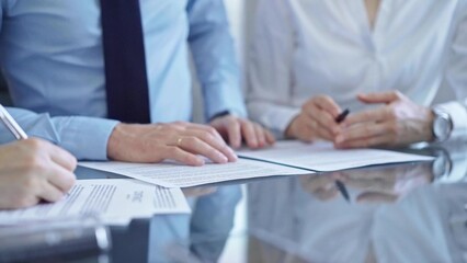 Business people are reviewing a contract and discussing the terms of the agreement. Lawyers at work