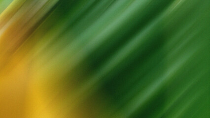 Abstract yellow and green background with blurred diagonal lines texture.