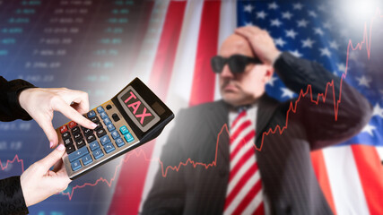 Tax burden in USA. Man investor clutching his head. Word taxes on calculator display. American businessman near graph of tax increases. Blurred investor upset by increase in taxes in USA.