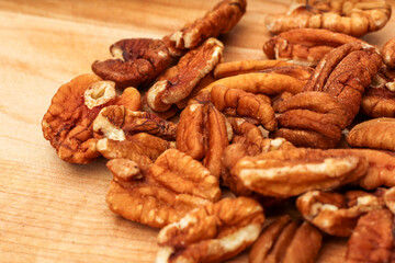 Closeup of Raw Pecans on Wooden Cutting Board