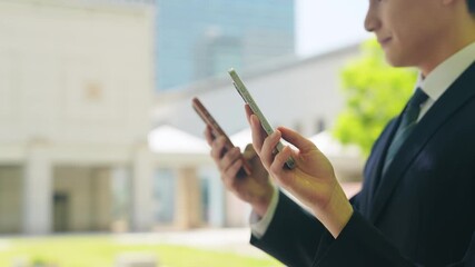 smartphone, smart phone, businessperson, people, app, outdoors, sharing, mobile, social media, video, two people, person, businessman, businesswoman, hand, fresh greenery, email, city, suit, business, - Powered by Adobe