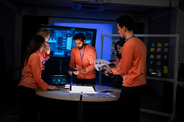 A cybersecurity team in a Security Operations Center analyzes a global threat map. They are collaborating on an incident response, tracking network intrusions in real-time.