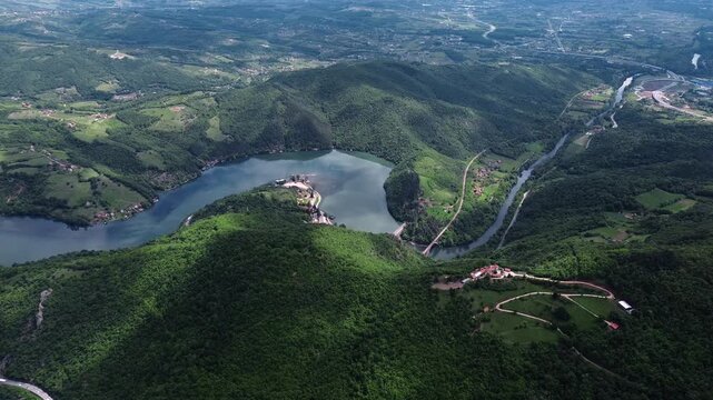 Drone view of Ovcar-Kablar Gorge in Serbia with the West Morava River, bridges, villages, and green hills creating a stunning landscape. Horizontal 4k footage.
