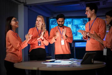 A successful team of app developers proudly presents their completed project. The diverse group is happy with the results of their hard work and effective collaboration.