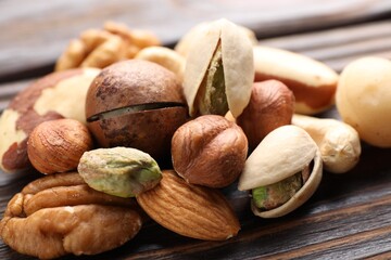Mix of different nuts on wooden table, closeup