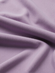 close up of purple lavender folded and twisted woolen fabric background