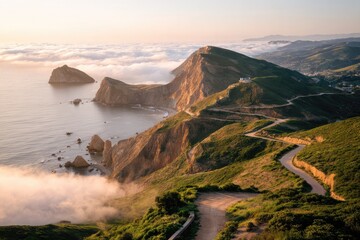 Fototapeta premium Coastal cliffs and winding road through mist at sunrise