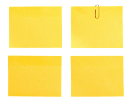 Four blank, light yellow sticky notes arranged in a grid. One note features a small, gold binder clip