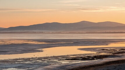Frozen Lake At Sunrise With Mountain Silhouette