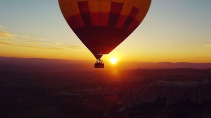 Obraz premium Breathtaking hot air balloon ride at sunrise over Cappadocia's surreal landscape offering a sense
