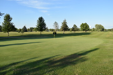 Manicured golf course fairway on a bright and sunny summer afternoon.