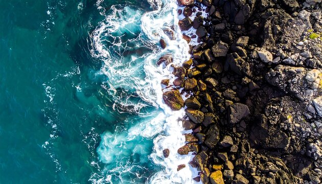 Aerial view of crashing waves on rocky coastline