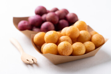 Deep fried sweet potato balls in paper bowl, Thai street food snack