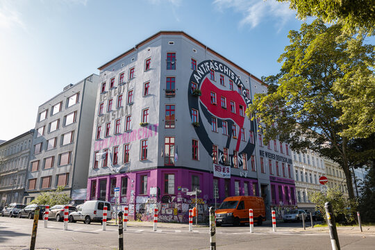 BERLIN, GERMANY - 6. August 2025: Building in the Scharnweberstrasse 38 in Friedrichshain. Provocative facade design with a big Antifa logo. The project Scharni38 offers social services.
