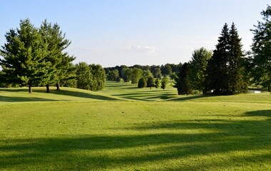 Manicured golf course fairway on a bright and sunny summer afternoon.