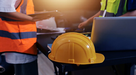 Closeup of team of industrial engineers meeting analyze machinery blueprints consult project on table in manufacturing factory. Working in manufacturing plant or production plant.