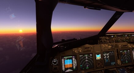 Sunset in the flightdeck. Cockpit view of Boeing 737, showing flight instruments, controls at dawn