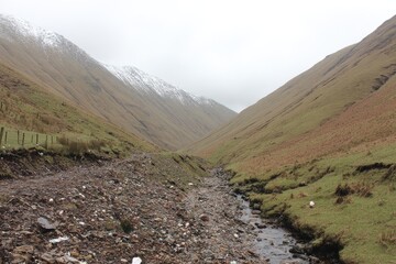 Misty mountain valley with a stream