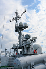 Fragment of a Russian warship with a locator on the mast and torpedos on a pier in the city of...