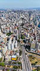 Aerial vertical panorama of São Paulo’s city center filled with tall buildings, avenues, and a...