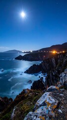 Moonlit coastal cliffs at night