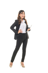 A confident woman in a business suit poses with a tablet, embodying professionalism and modern business attire.